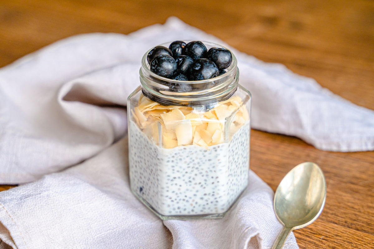 Chia pudding in a jar with blueberries and almond flakes