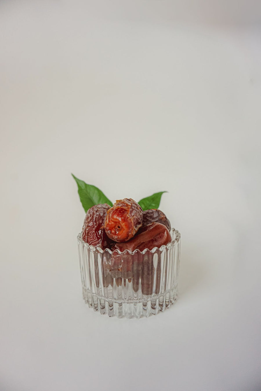 Dried dates in a glass bowl