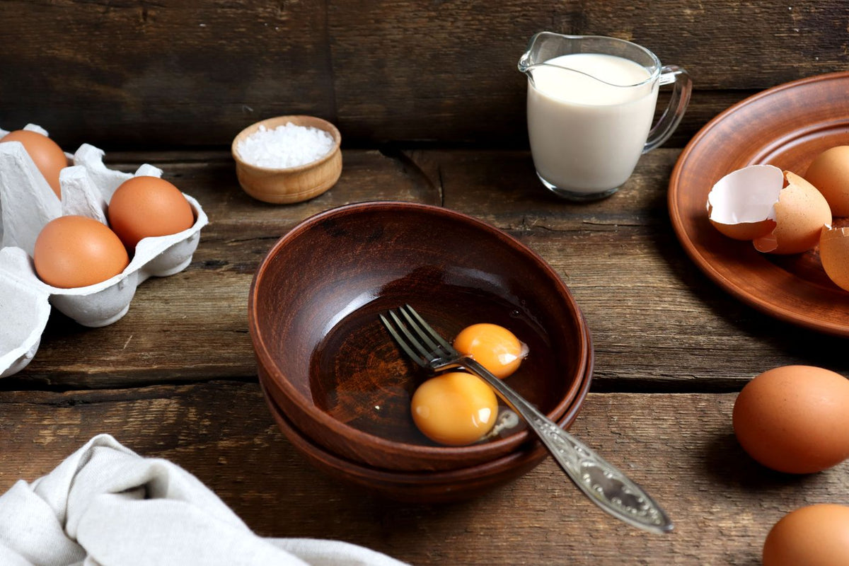 Eggs and milk on a rustic wooden table