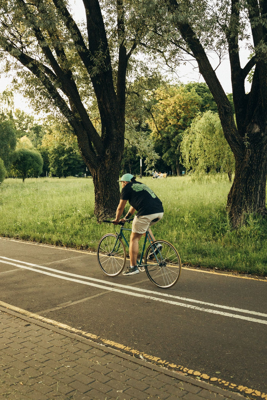 A man cycling on a park path
