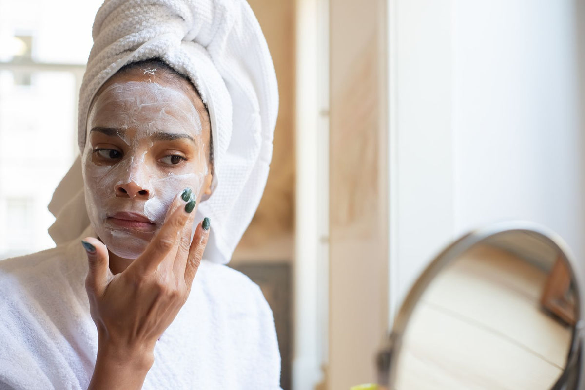 Woman applying moisturising cream to her face