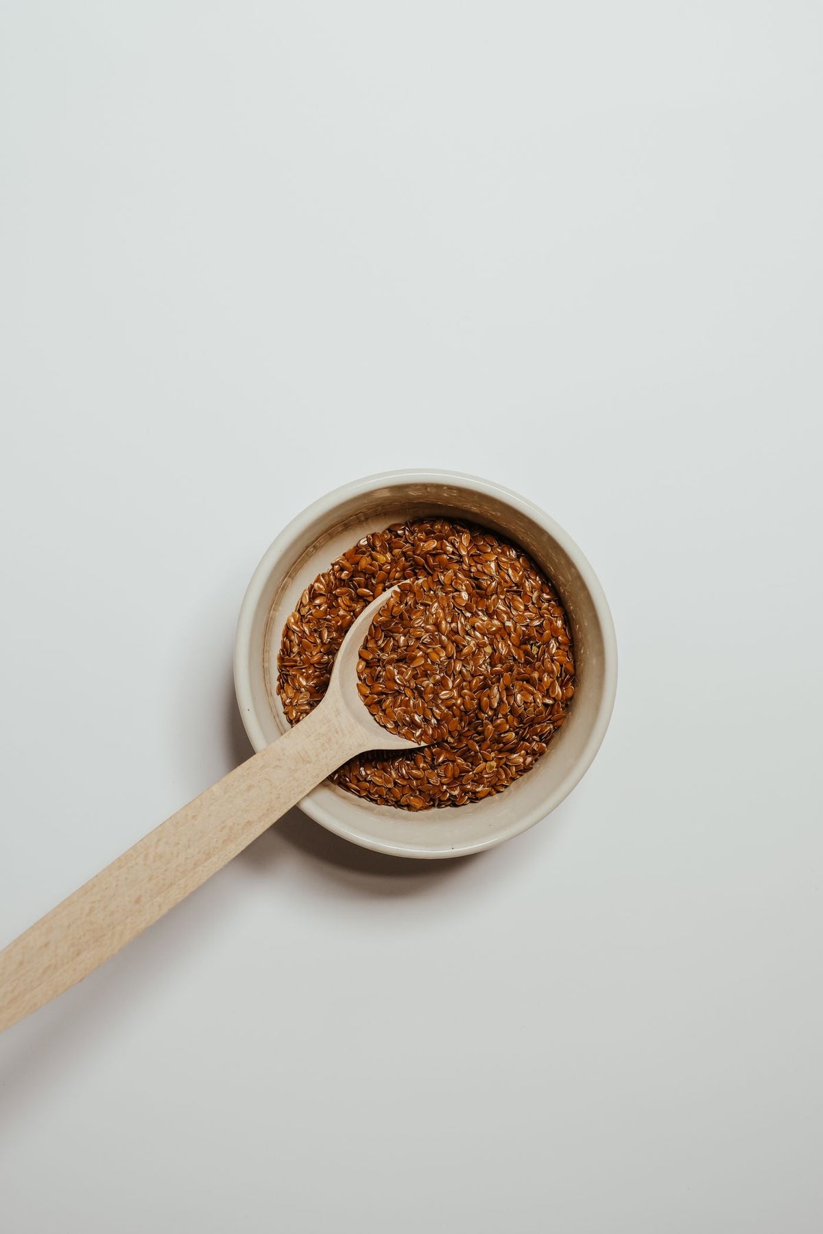 Flax seeds (alsi) in a bowl with a wooden spoon