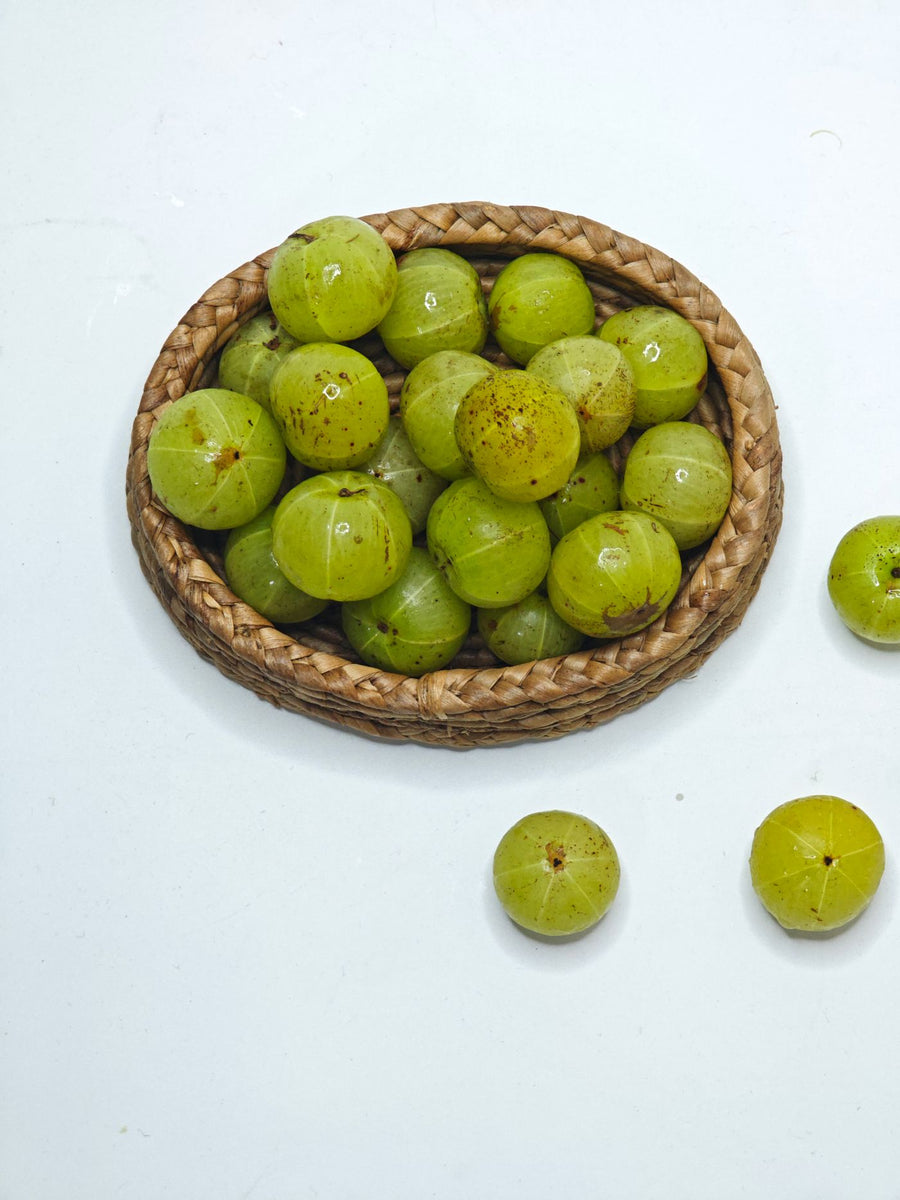Fresh amla (Indian gooseberry) in a wicker basket