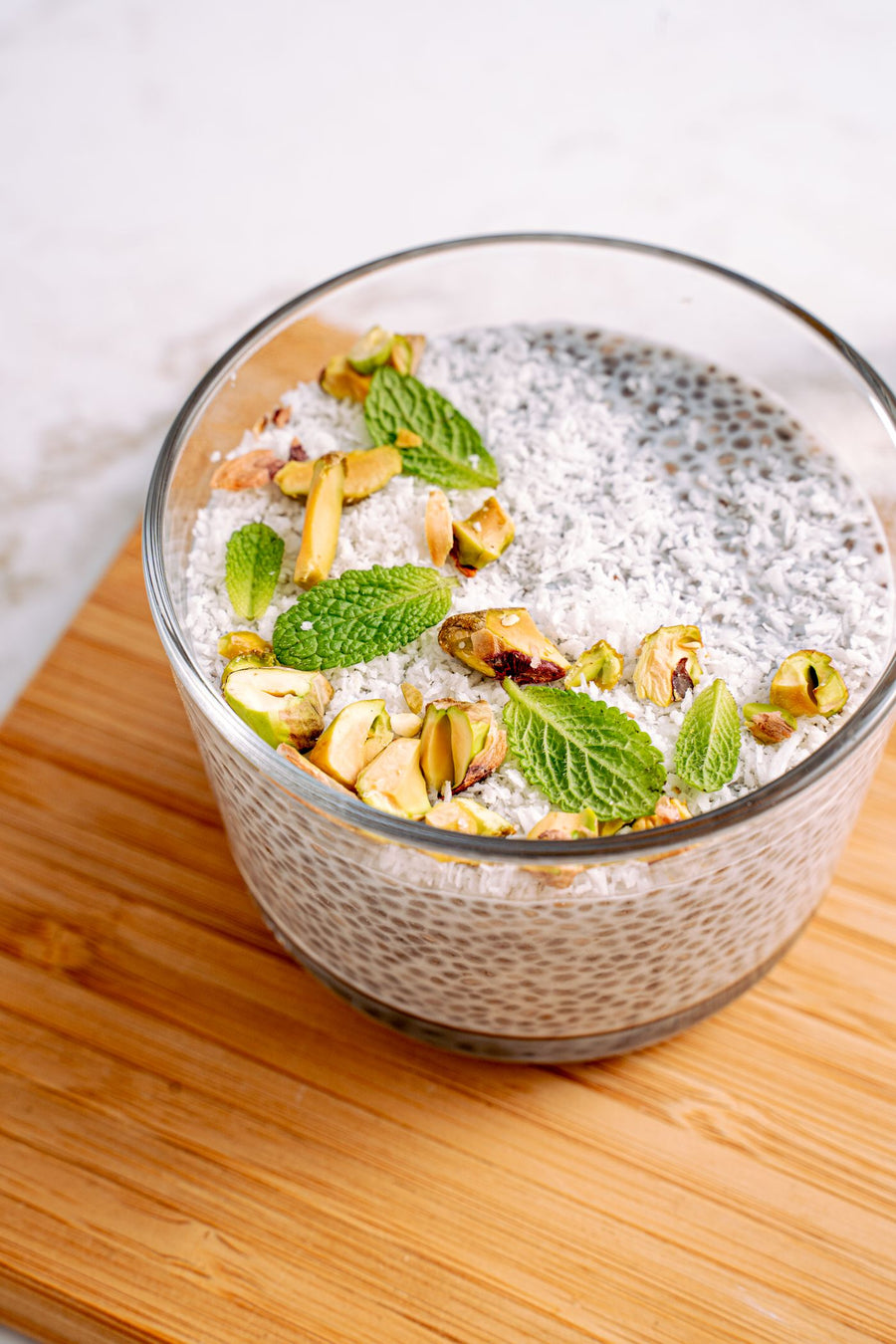 Chia pudding topped with pistachios and mint