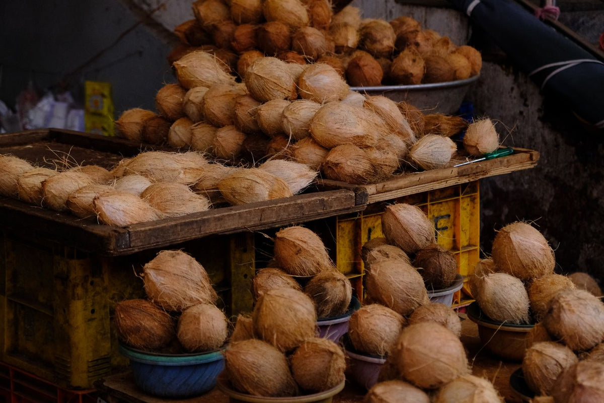 Green coconuts piled up at a market stall in Bengaluru