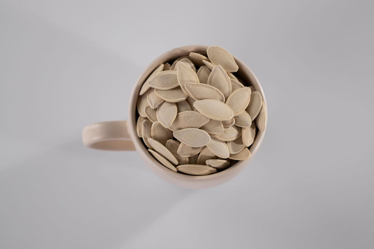 Pumpkin seeds in a white ceramic mug