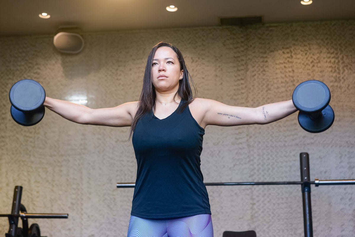 Woman lifting dumbbells in a gym