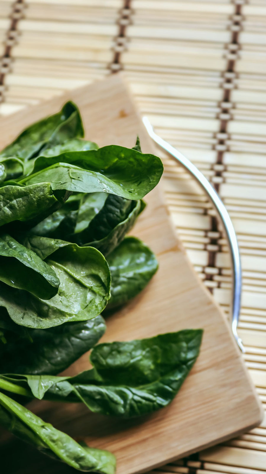 Fresh spinach leaves on a wooden board