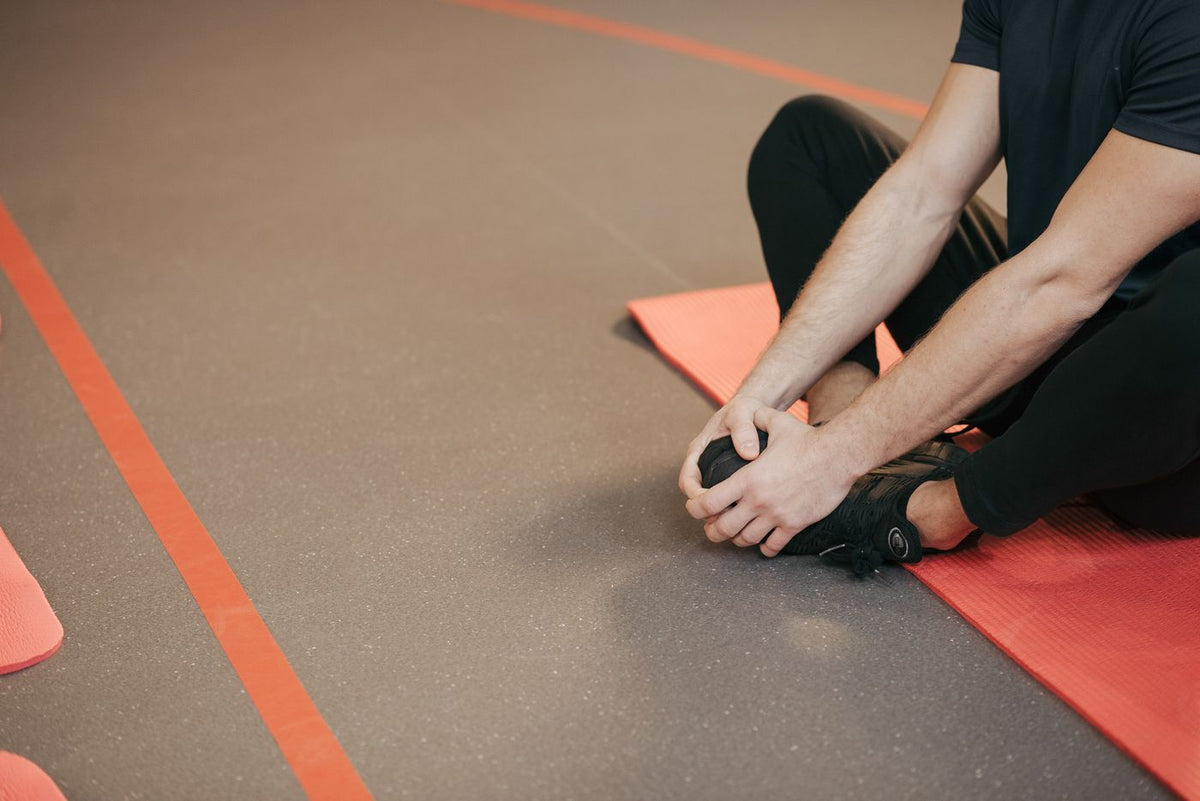 A man stretching on an exercise mat