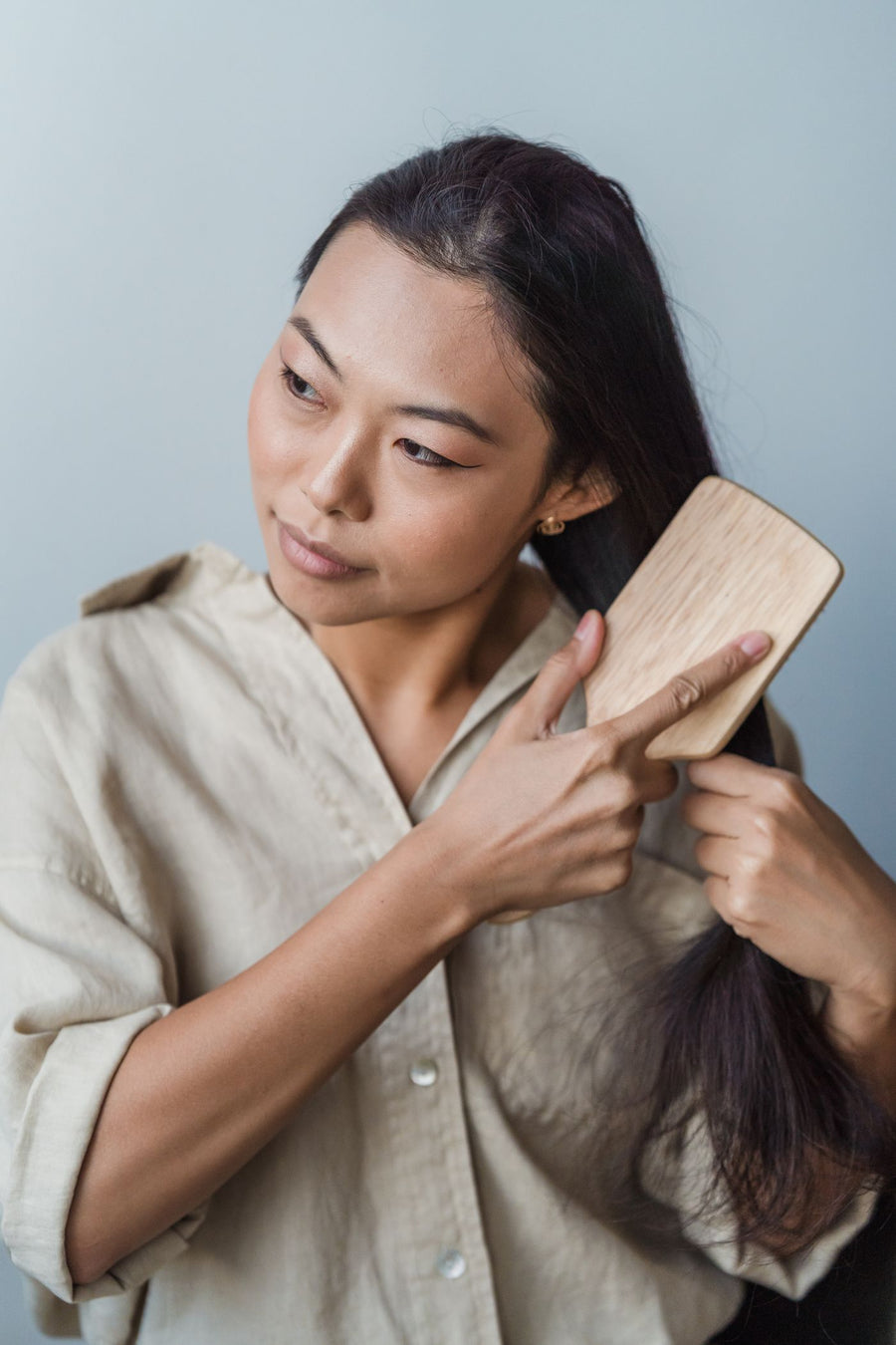 A woman brushing her long dark hair