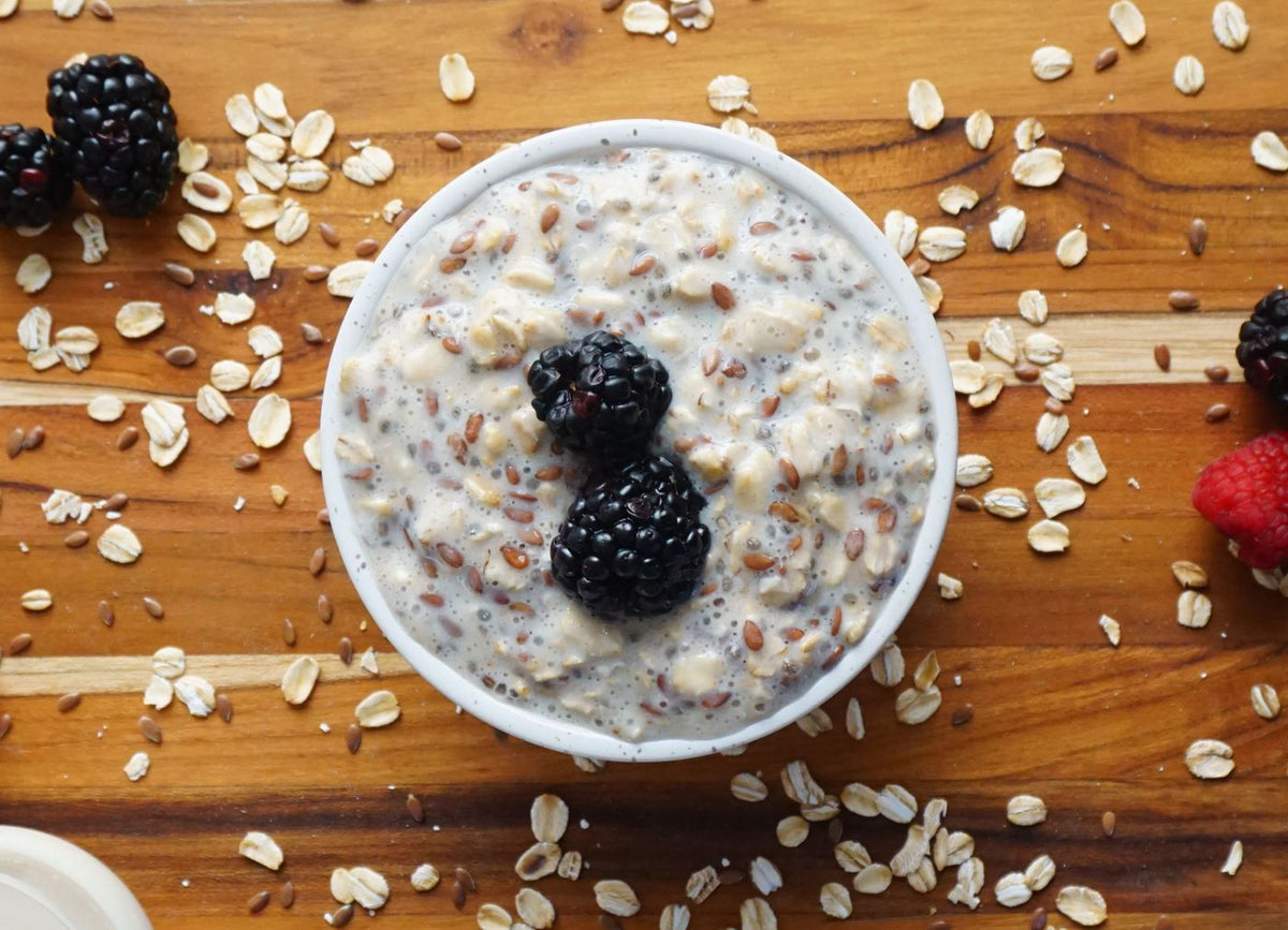 Bowl of oats topped with flax seeds and blackberries