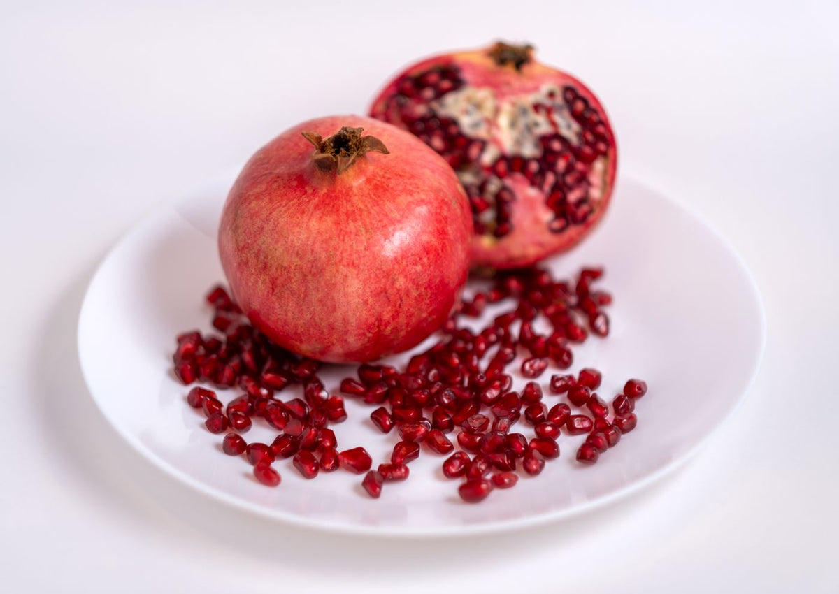 Fresh pomegranates on a white plate