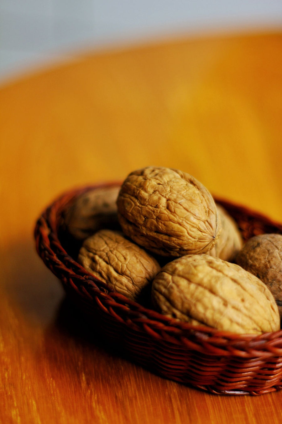 Walnuts (akhrot) in a basket on a wooden table